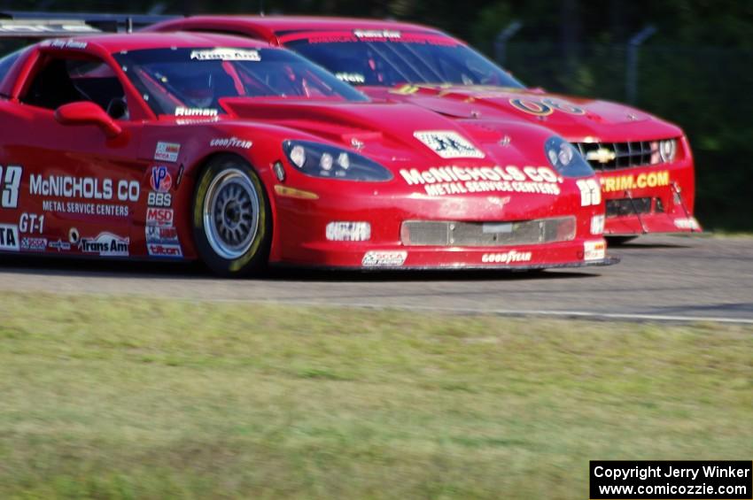 Amy Ruman's Chevy Corvette passes Bob Stretch's Chevy Camaro into turn three.