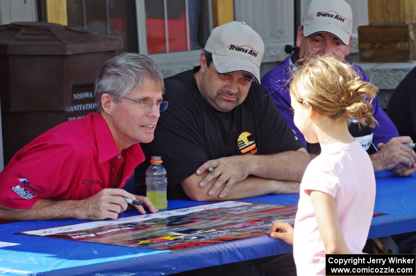 Pete Halsmer and Tony Ave sign autographs for a young fan.