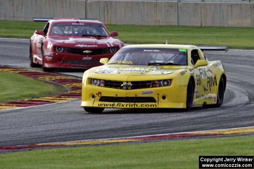 Bob Stretch's Chevy Camaro and Cameron Lawrence's Chevy Camaro battle for the lead in TA2