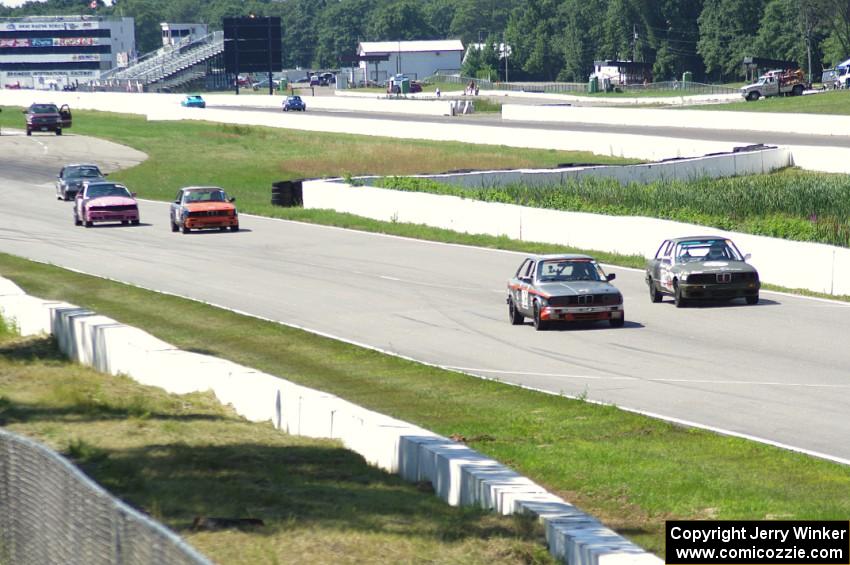 Five cars head down the front straight