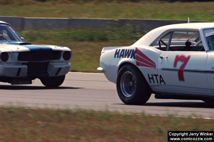 Shannon Ivey's Chevy Camaro leads Brian Kennedy's Ford Shelby GT350 into turn 4