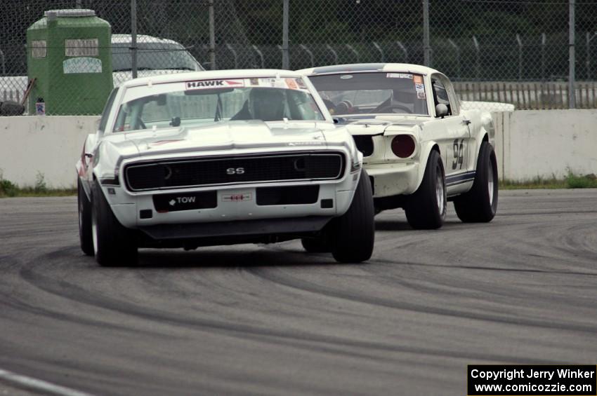 Shannon Ivey's Chevy Camaro leads Brian Kennedy's Ford Shelby GT350 into turn 12