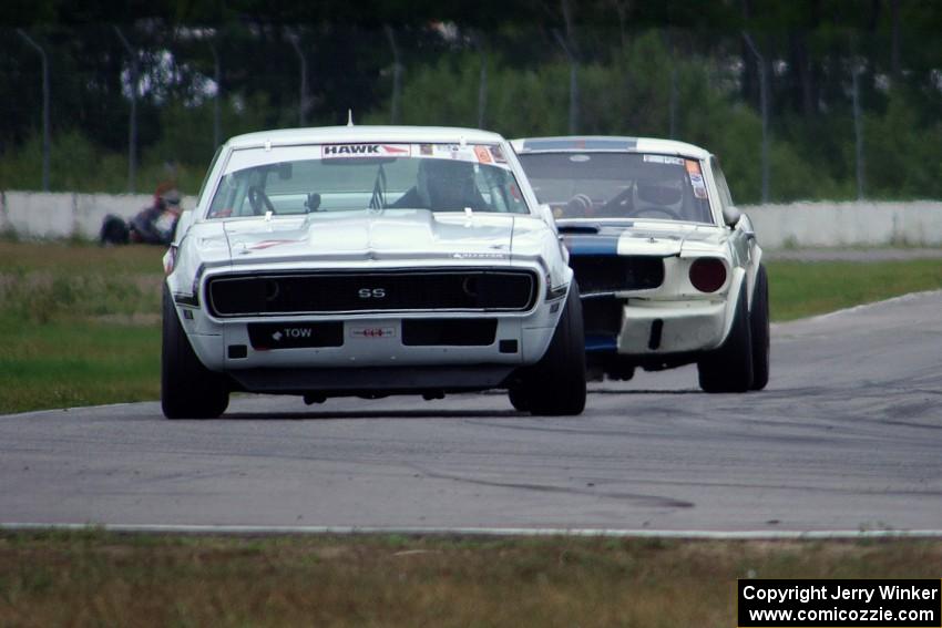 Shannon Ivey's Chevy Camaro leads Brian Kennedy's Ford Shelby GT350 into turn 12