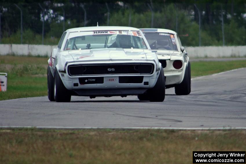 Shannon Ivey's Chevy Camaro leads Brian Kennedy's Ford Shelby GT350 into turn 12