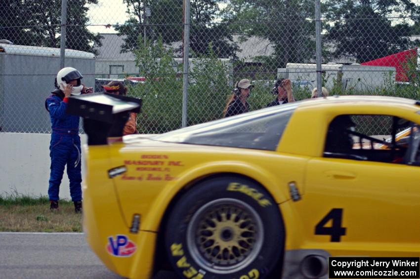 Dale Madsen parks his Ford Mustang after an accident on the re-start. Tony Ave's Chevy Corvette passes by.