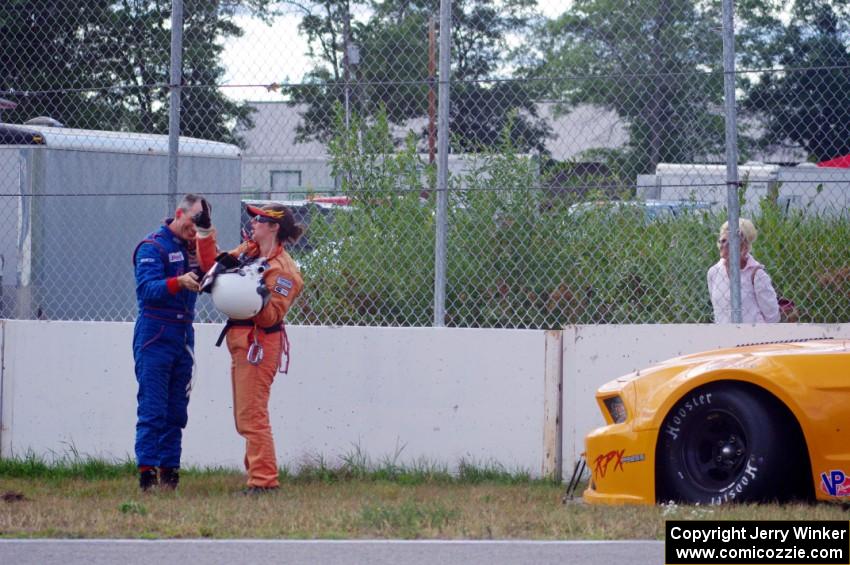 Dale Madsen parks his Ford Mustang after an accident on the re-start