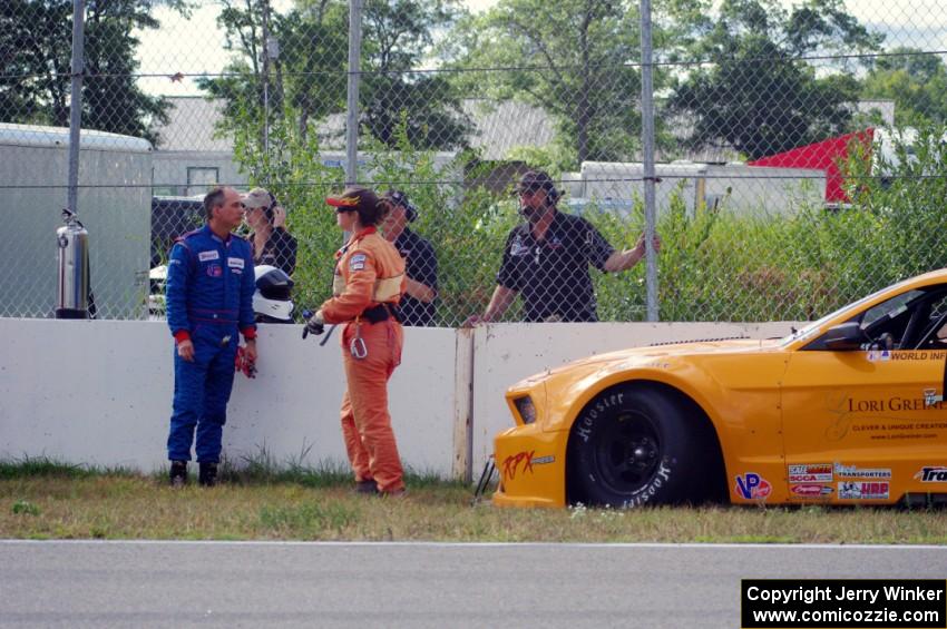 Dale Madsen parks his Ford Mustang after an accident on the re-start