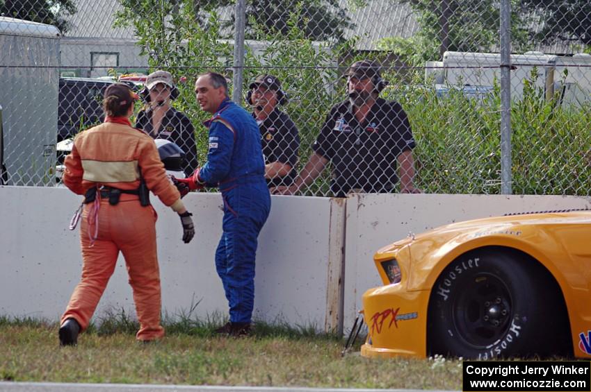 Dale Madsen parks his Ford Mustang after an accident on the re-start