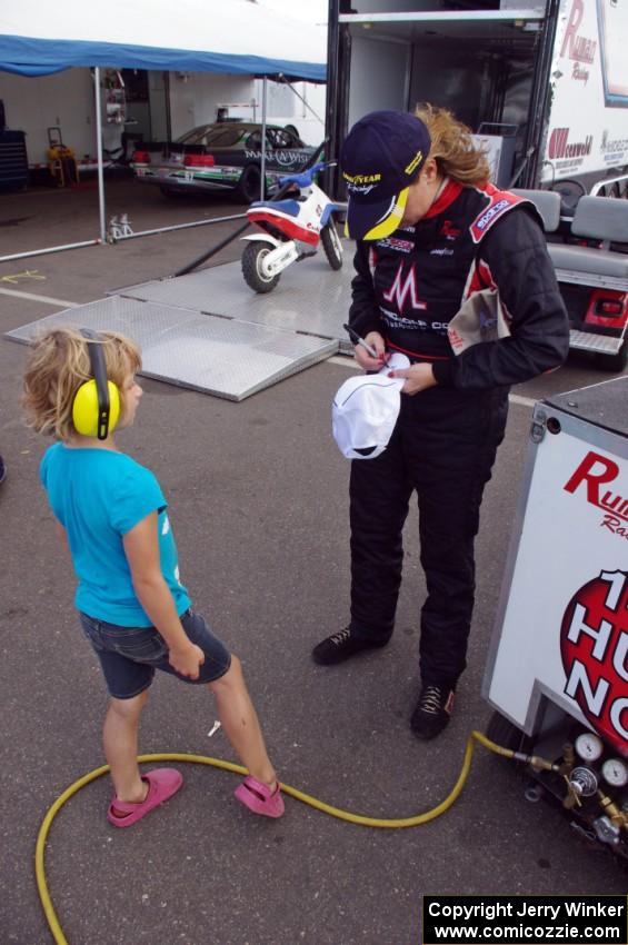 Amy Ruman signs an autograph for a young fan