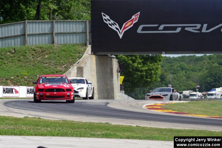 Joey Atterbury / Tim Bell Ford Mustang Boss 302R GT holds off a pair of Aston Martin Vantages