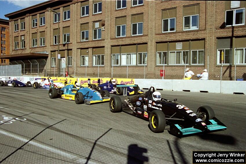 The front of the field comes through turn 9 on the first lap.