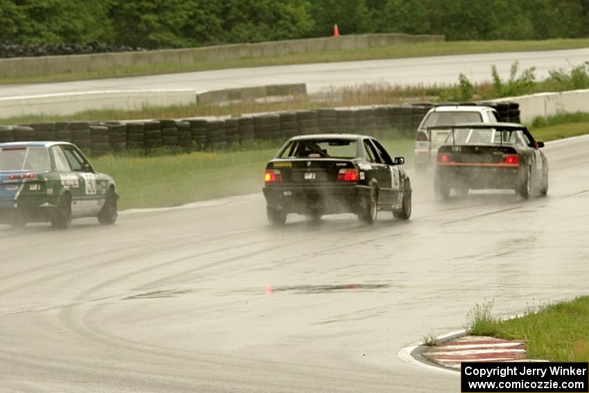 Four cars come out of turn 13 onto the front straight.