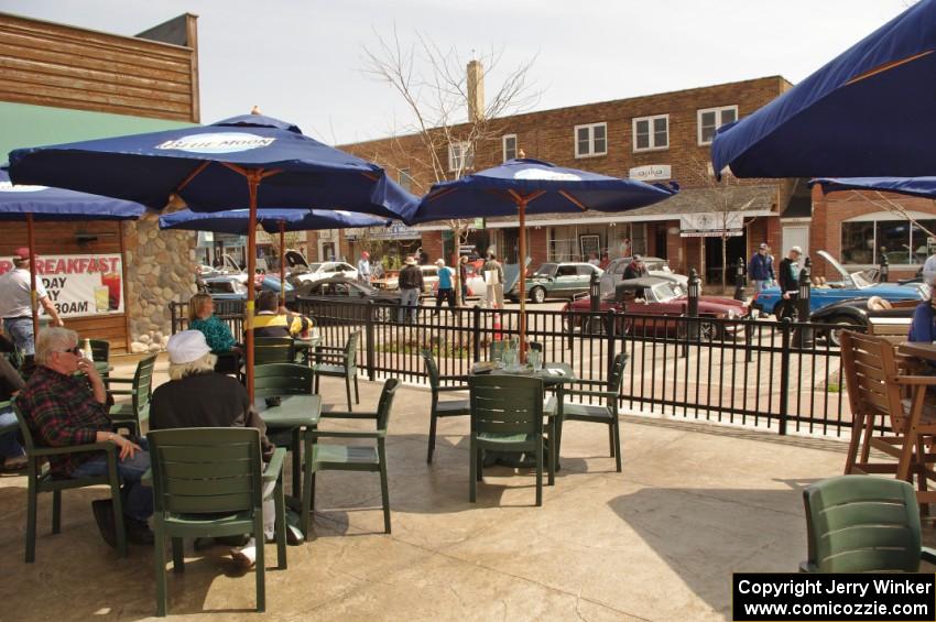 An outdoor patio makes for a wonderful view of the car show.