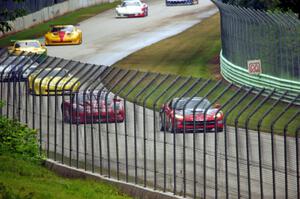 The field follows the pace car into turn 12