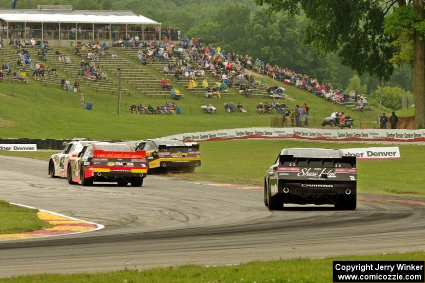 Dylan Kwasniewski's, Brendan Gaughan's (in the dirt), Ty Dillon's and Brian Scott's Chevy Camaros battle at turn 6.