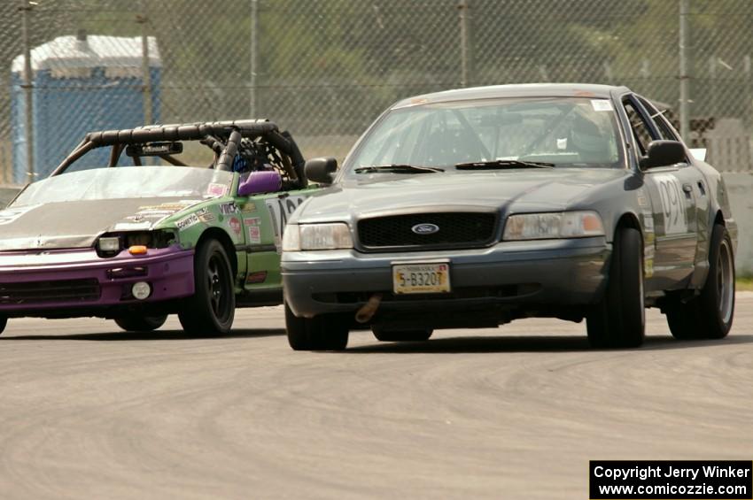 Moss Racing Ford Crown Victoria passes the Danger Zone Racing Honda CRX