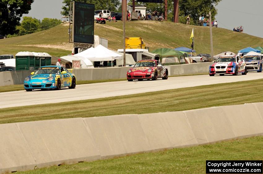 Matt Plumb / Nick Longhi Porsche 997 leads the field into turn 8.