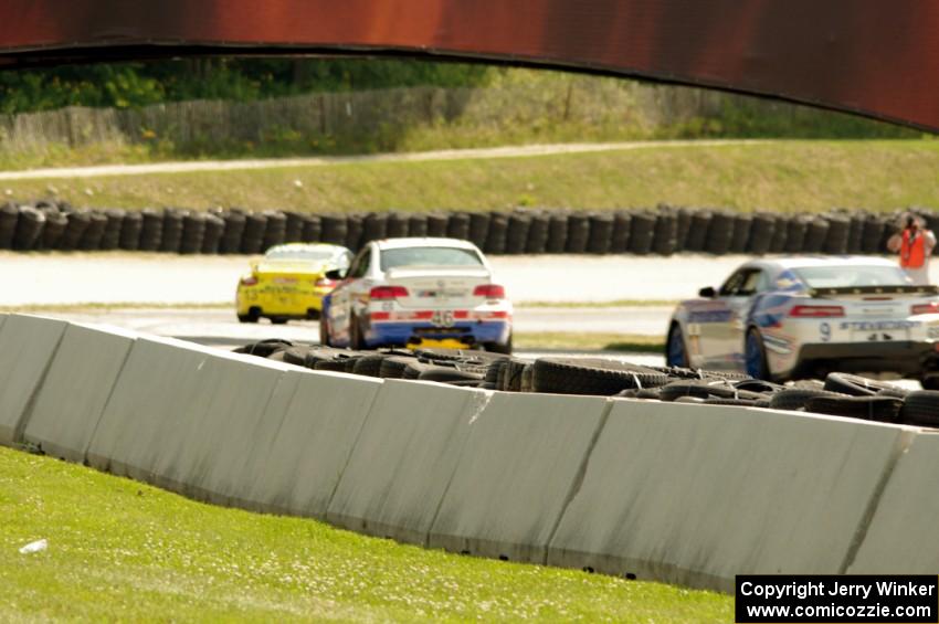 Matt Plumb / Nick Longhi Porsche 997 leads the field into the carousel.