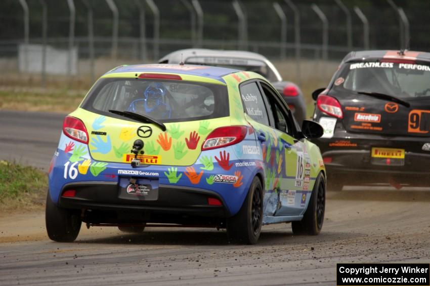 Michael Ashby's Mazda 2 chases Michael Pettiford's Pontiac Solstice and Chris Holter's Mazda 2