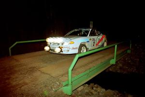 Paul Choiniere / Jeff Becker Hyundai Tiburon at speed across the final bridge on SS10, Menge Creek.