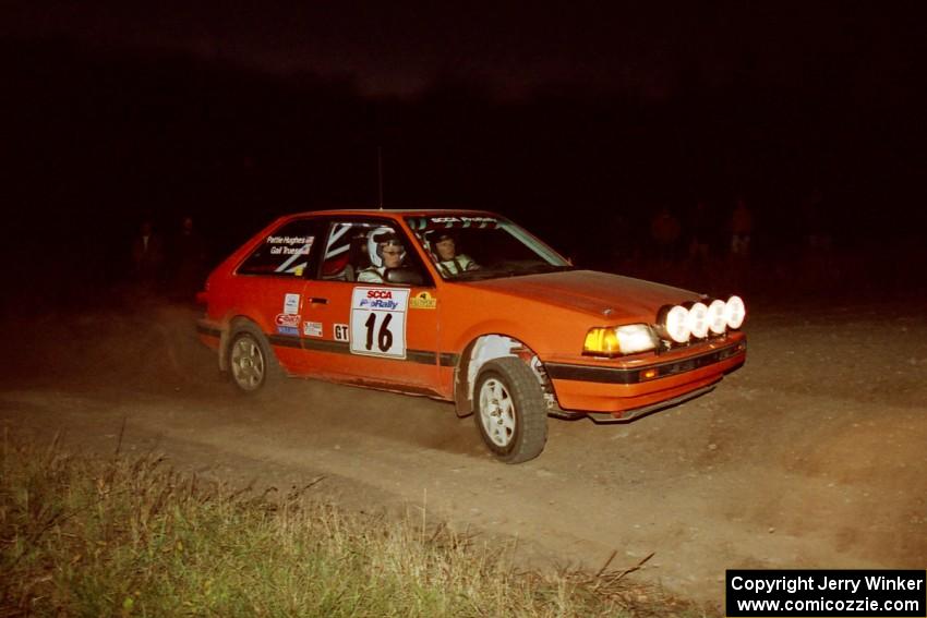 Gail Truess / Pattie Hughes Mazda 323GTX at the spectator corner on SS4, Far Point I.