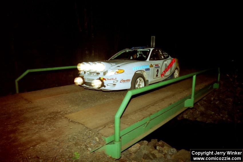 Paul Choiniere / Jeff Becker Hyundai Tiburon at speed across the final bridge on SS10, Menge Creek.