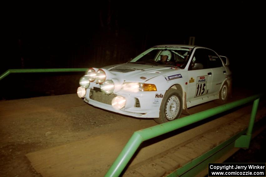 Seamus Burke / Frank Cunningham Mitsubishi Lancer Evo IV at speed across the final bridge on SS10, Menge Creek.