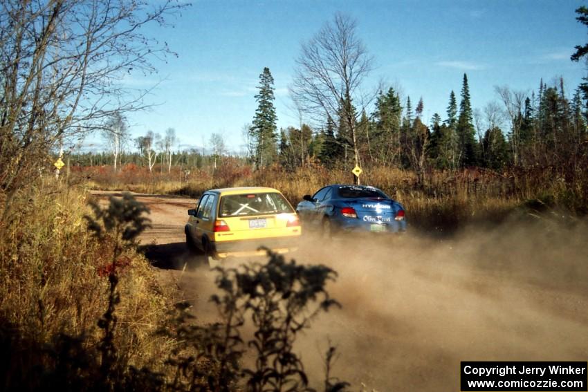 Art Burmeister / Bob Martin VW GTI passes the Perry King / Mark Williams Hyundai Tiburon near the end of SS17, Gratiot Lake II.