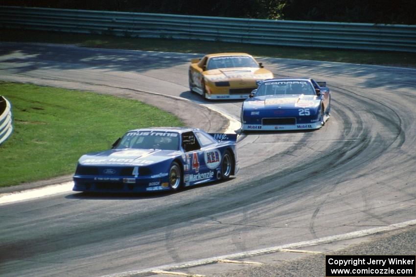 Ron Fellows' Ford Mustang, Jack Baldwin's Chevy Camaro and Scott Sharp's Chevy Camaro