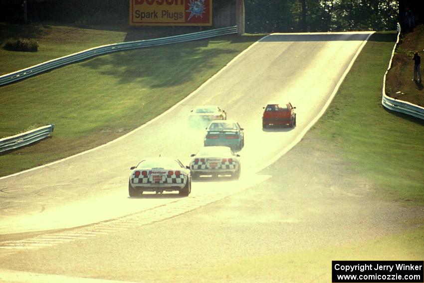 The leaders pass backmarkers on their way uphill to turn 6.