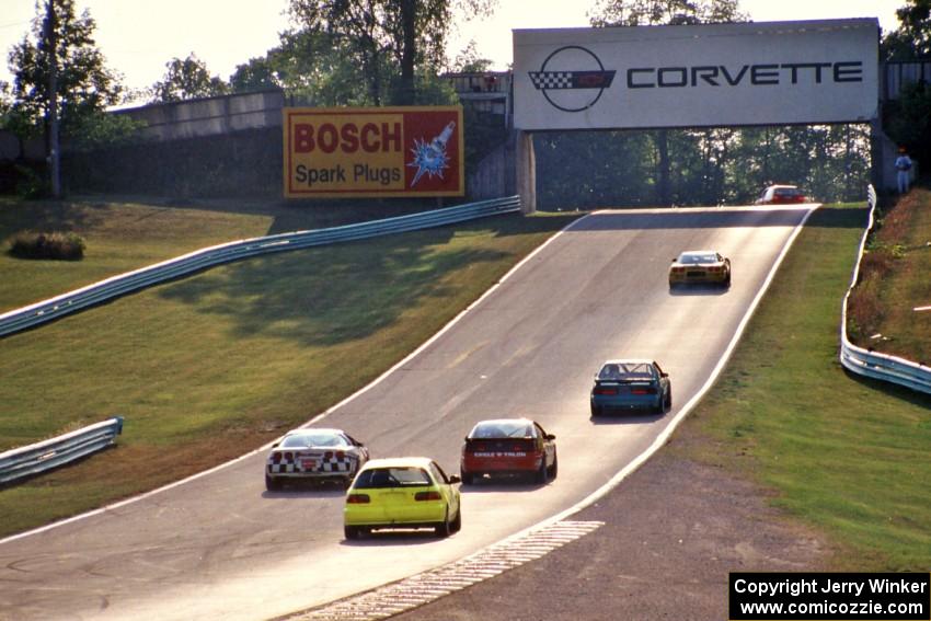 The leaders pass backmarkers on their way uphill to turn 6.