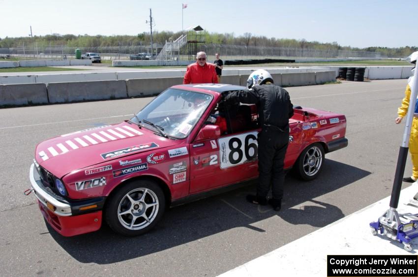 Missing Link Motorsports BMW 325i in the pits during a driver's change.