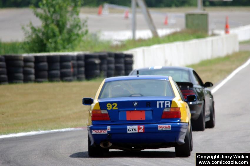 Andy Orr's GTS2 BMW 325i chases Jeff Demetri's American Iron Ford Mustang