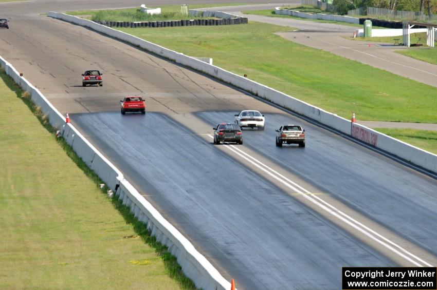 Five cars head down the front straight into turn 1.