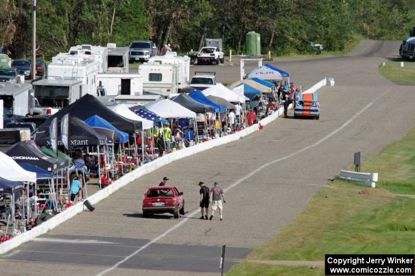 Bromance Racing Ford Mustang and Cheap Shot Racing BMW 325is in the pits.