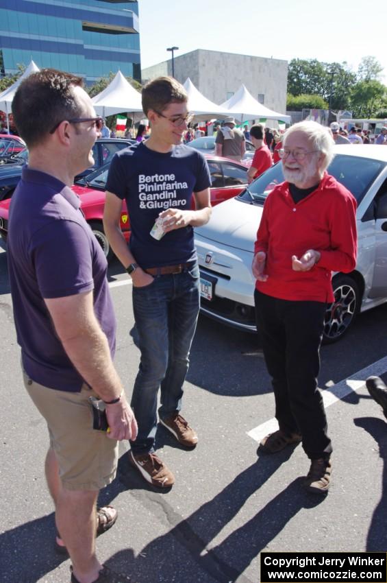 Ed Solstad talks foreign cars to a couple of passers-by.