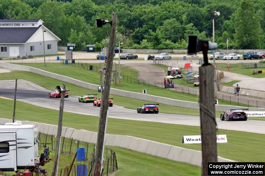 Five cars run nose to tail into turn 8.