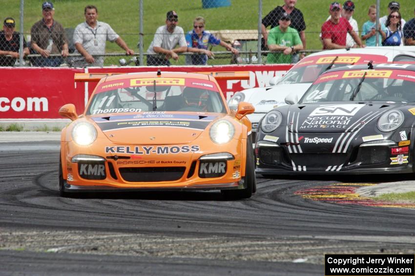 Colin Thompson's, Sloan Urry's and Alec Udell's Porsche 911 GT3 Cup cars battle into turn 5.