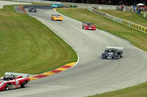 Can-Am cars stream through the Hurry Downs on lap one.