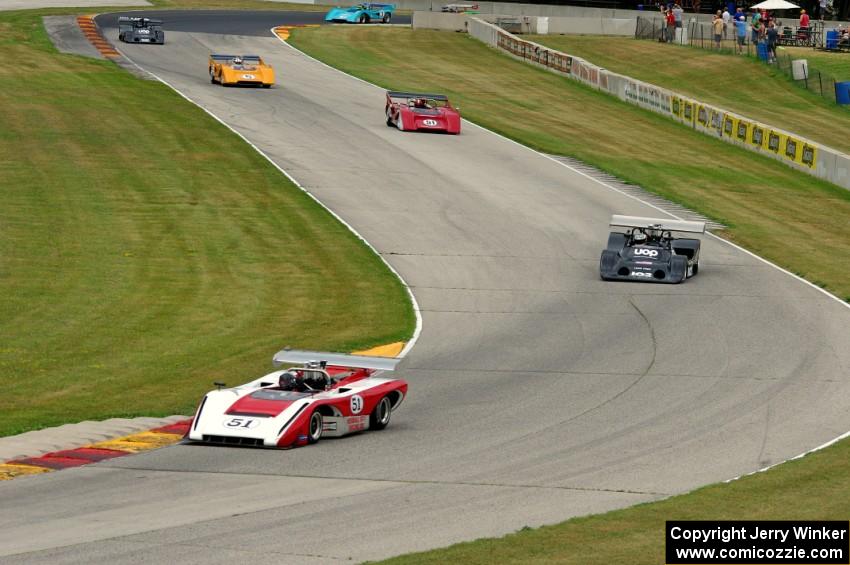 Can-Am cars stream through the Hurry Downs on lap one.