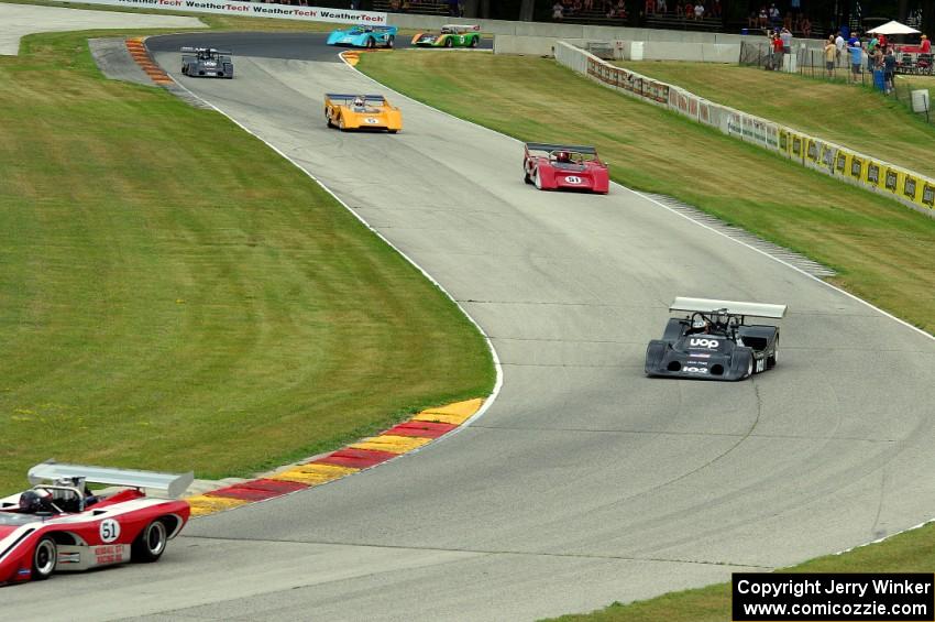 Can-Am cars stream through the Hurry Downs on lap one.