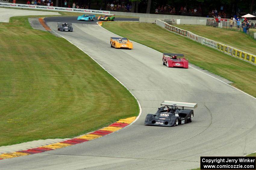 Can-Am cars stream through the Hurry Downs on lap one.