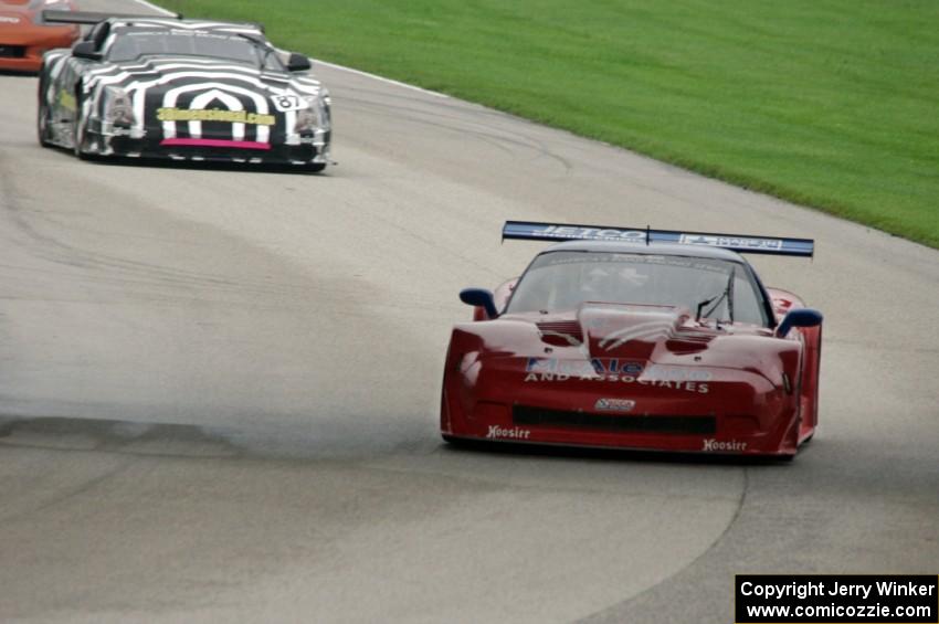 Jim McAleese's Chevy Corvette leads Doug Peterson's Cadillac CTS-V in the closing laps.