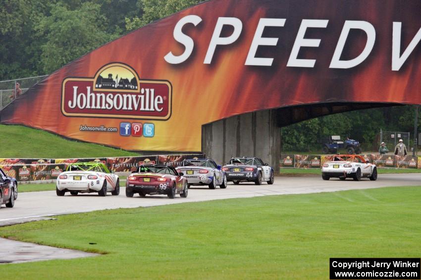 MX-5s head under the Johnsonville bridge into the carousel.