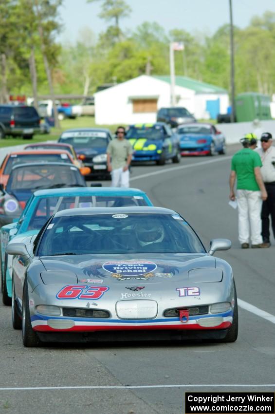 Bill Collins' T2 Chevy Corvette at the front of the grid for Race Group 5.