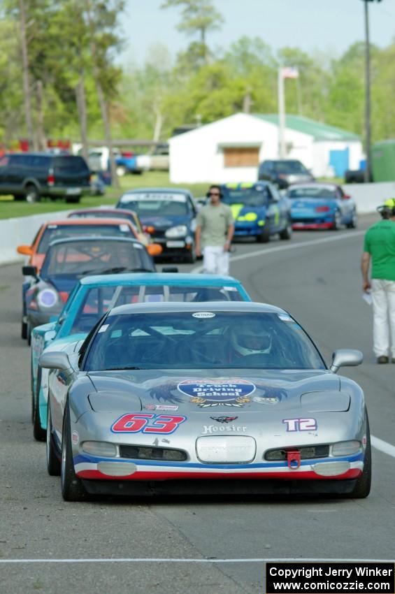 Bill Collins' T2 Chevy Corvette at the front of the grid for Race Group 5.