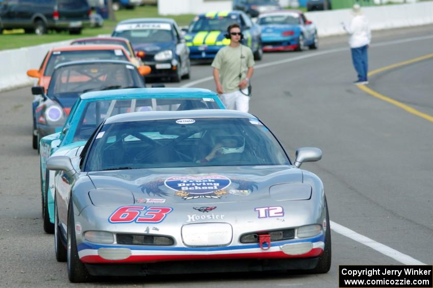 Bill Collins' T2 Chevy Corvette at the front of the grid for Race Group 5.