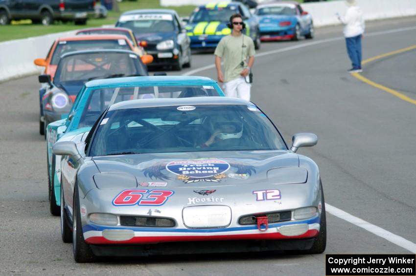 Bill Collins' T2 Chevy Corvette at the front of the grid for Race Group 5.