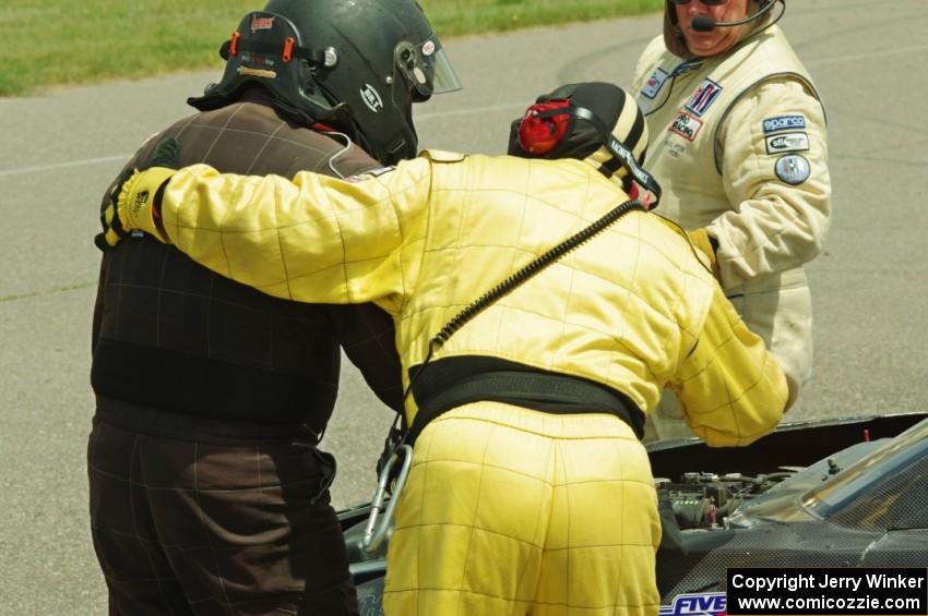 John Atwell is helped from his car by safety workers after pulling off course at turn 12.