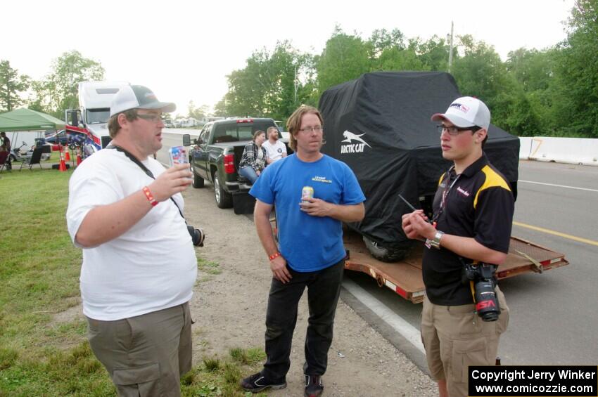 Ben Wedge, Brad Roettger and Patrick Palony chat on paddock road.